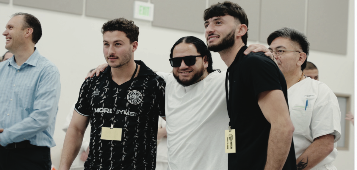 An EIT, or an entrepeneur in training, at Utah State Correctional Facility poses for a shot between Jacob Hozer (left) and Zack Lombardo (right) during the production of the film.